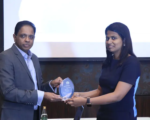 A teammate receiving the crystal Proactive Champion trophy
