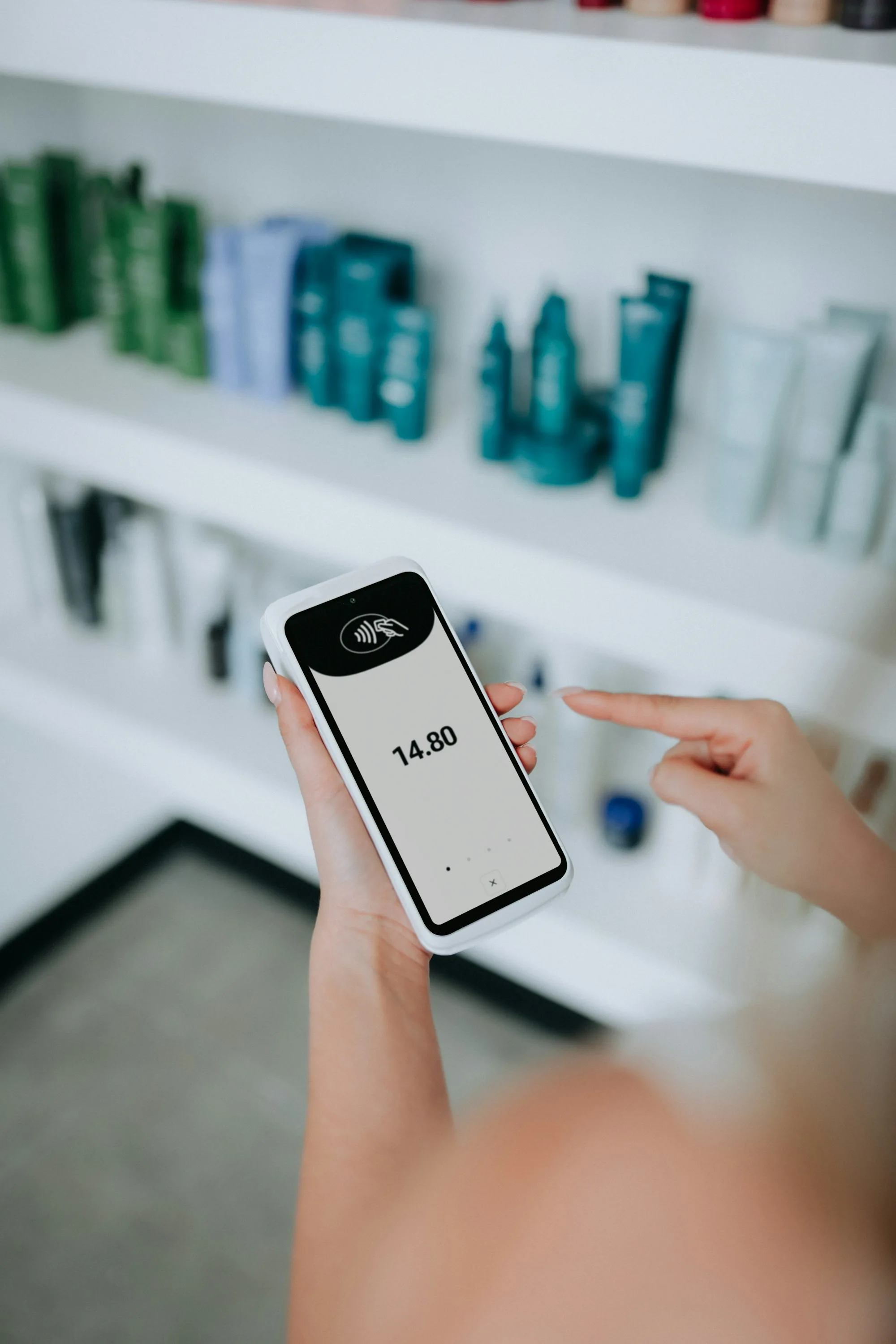 A contactless payment being authorized on a card reader from a smartphone wallet