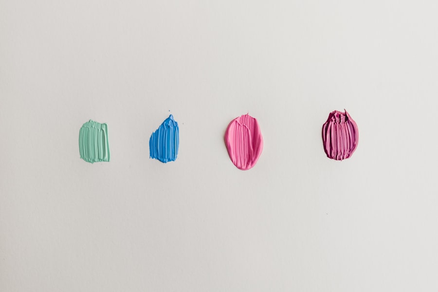 Four brushstrokes of paint in green, blue, pink and magenta
