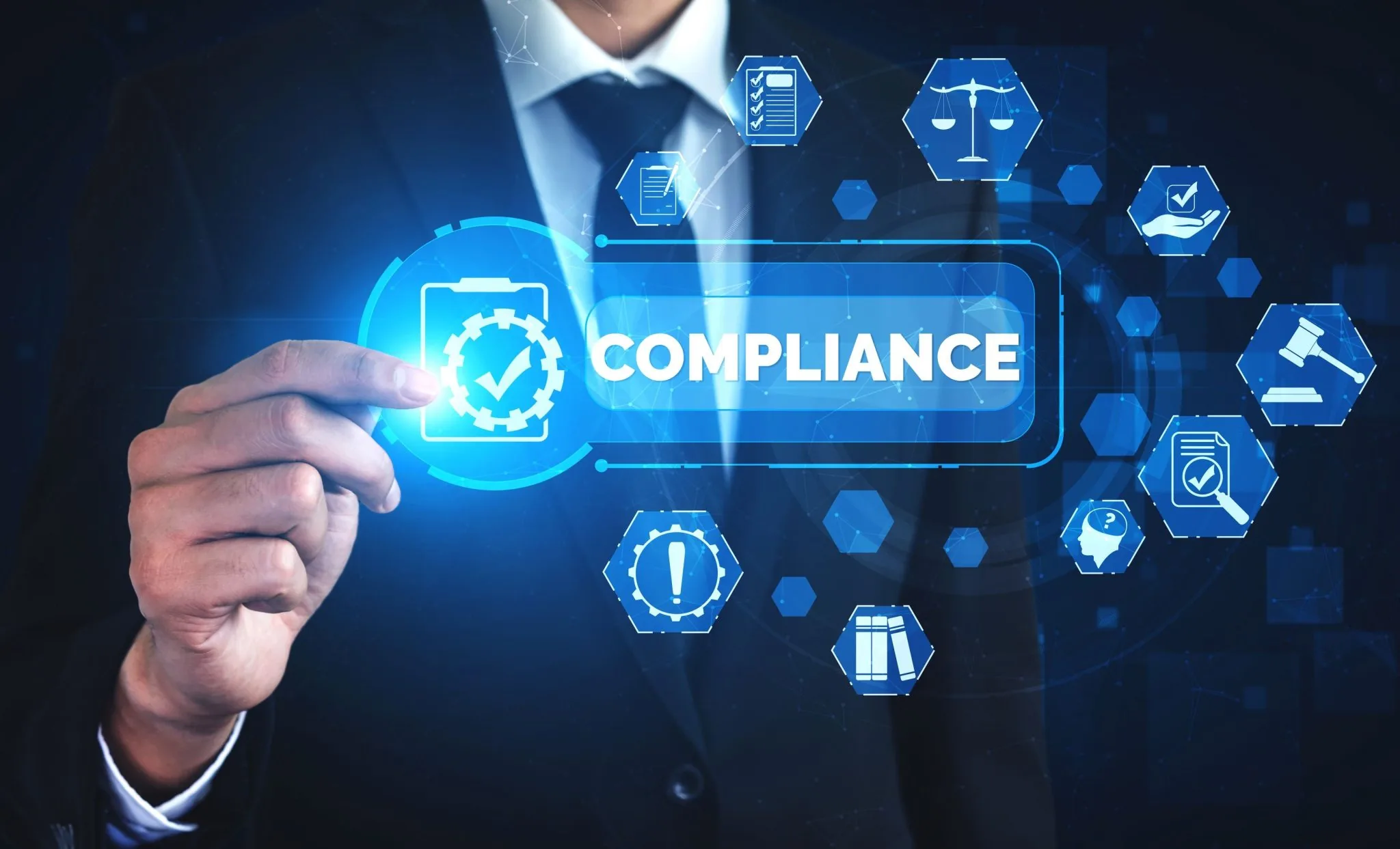 A businessperson's hand touching a glowing compliance interface with a checklist, scales of justice and gavel icons